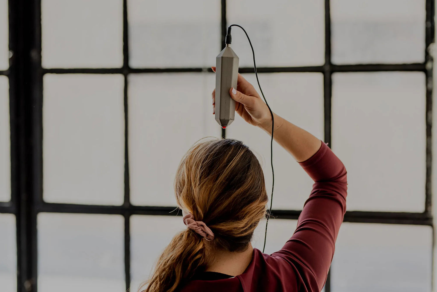 photo of a woman using the crystal wave on the top of her head
