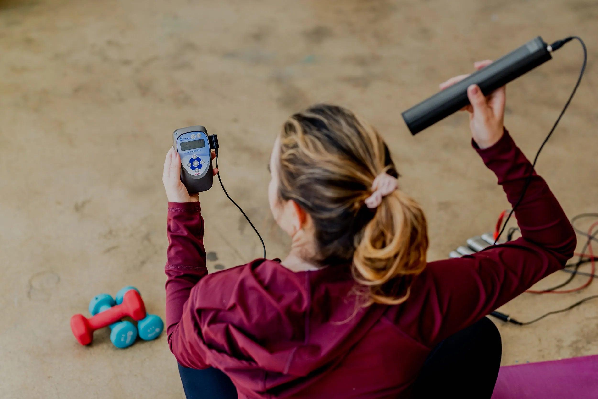photo of a woman using the biotrandsducer pro with the biomodulator pro on her head