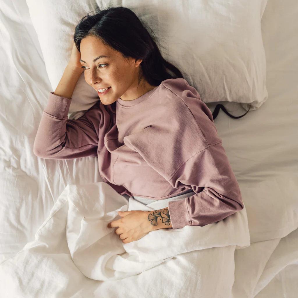 woman laying in the white duvet