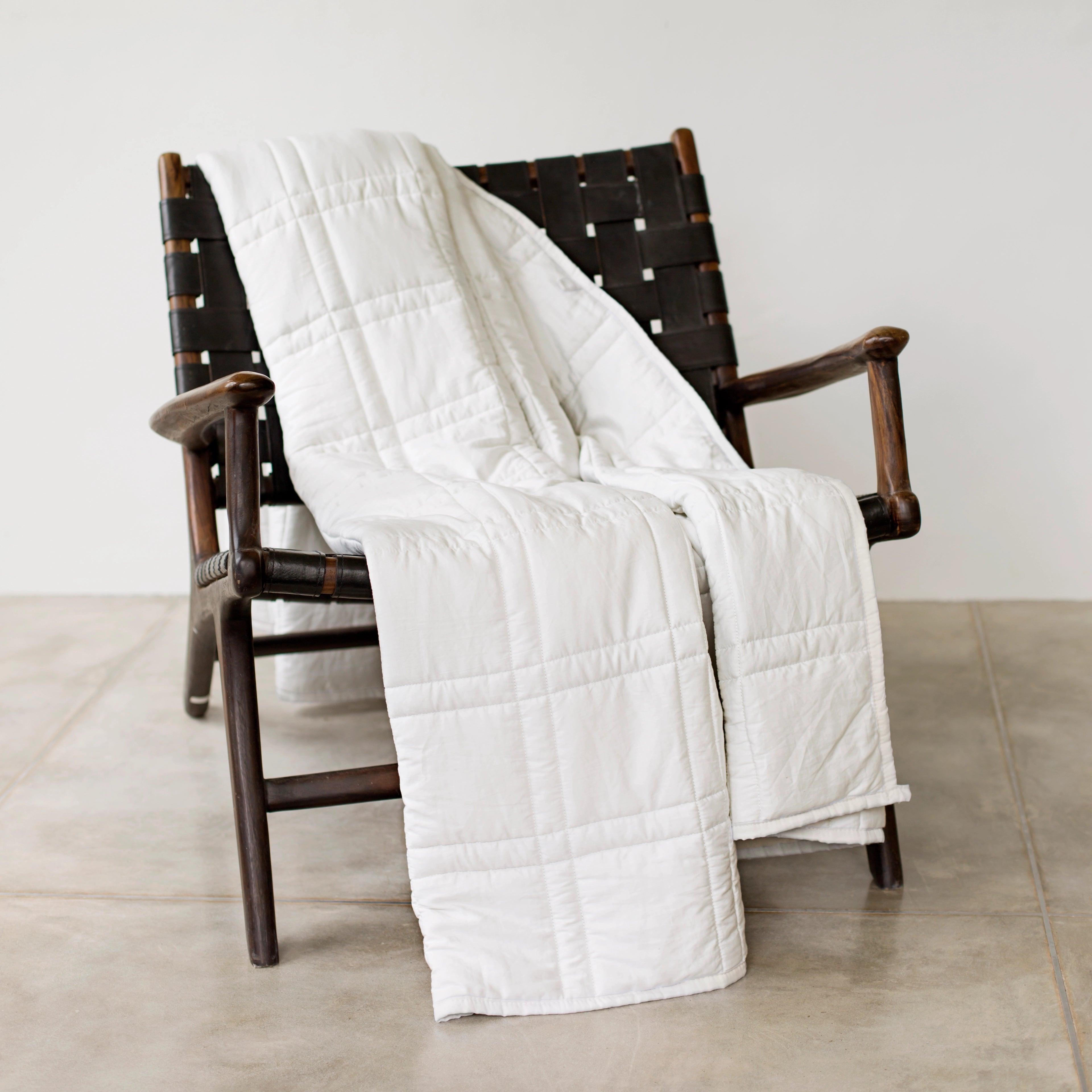 photo of the pebble white throw draped across a chair