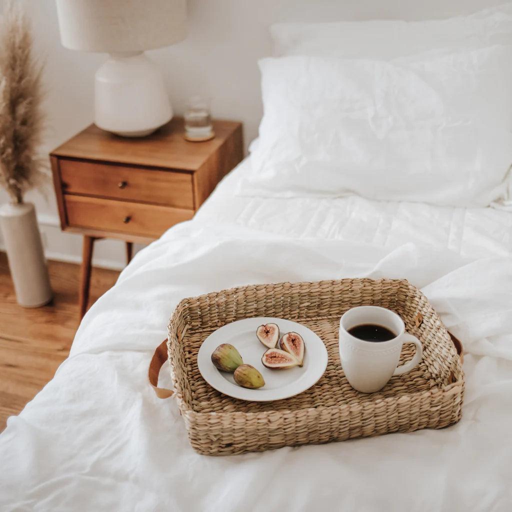 white duvet with a breakfast tray on top
